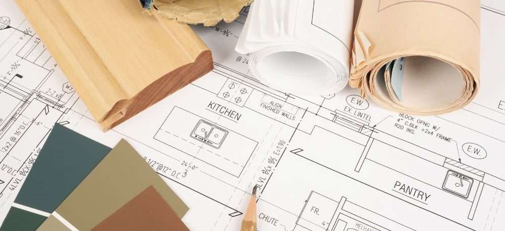 Background image, showing a work table covered in tools, construction and home improvement blueprints